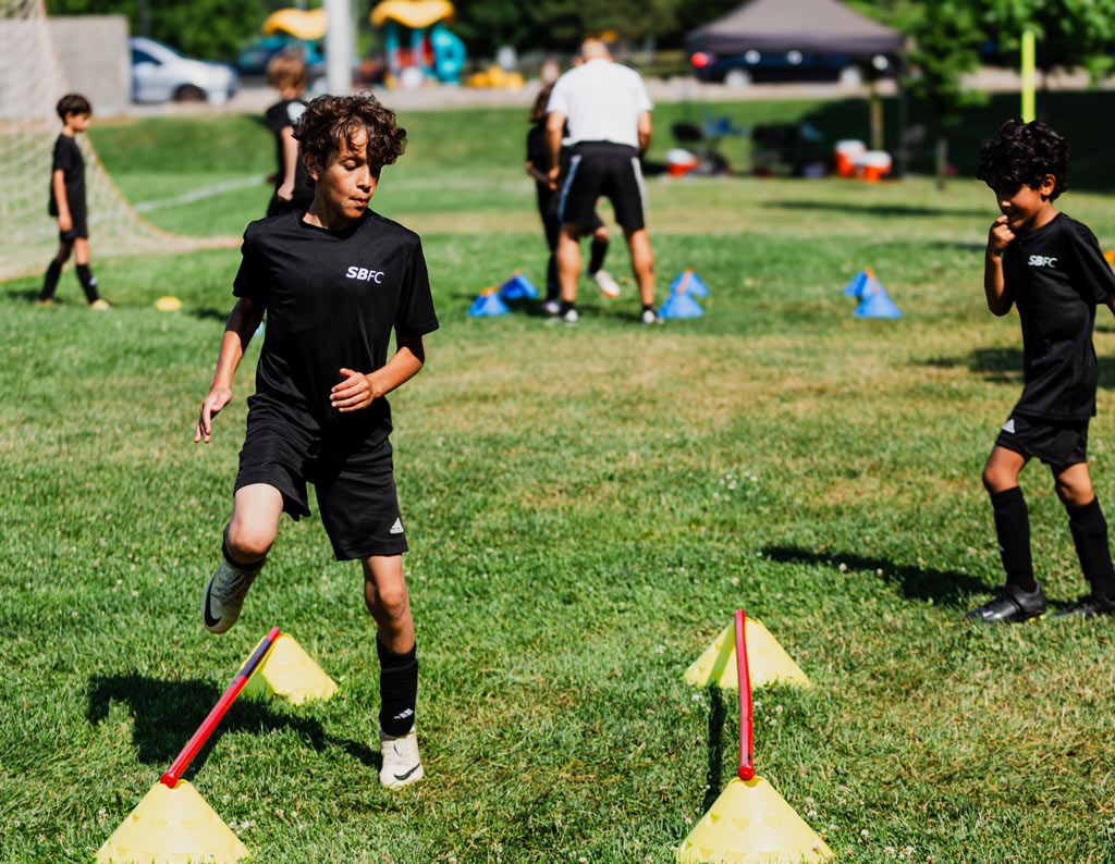 U11 player focused on dynamics warm up